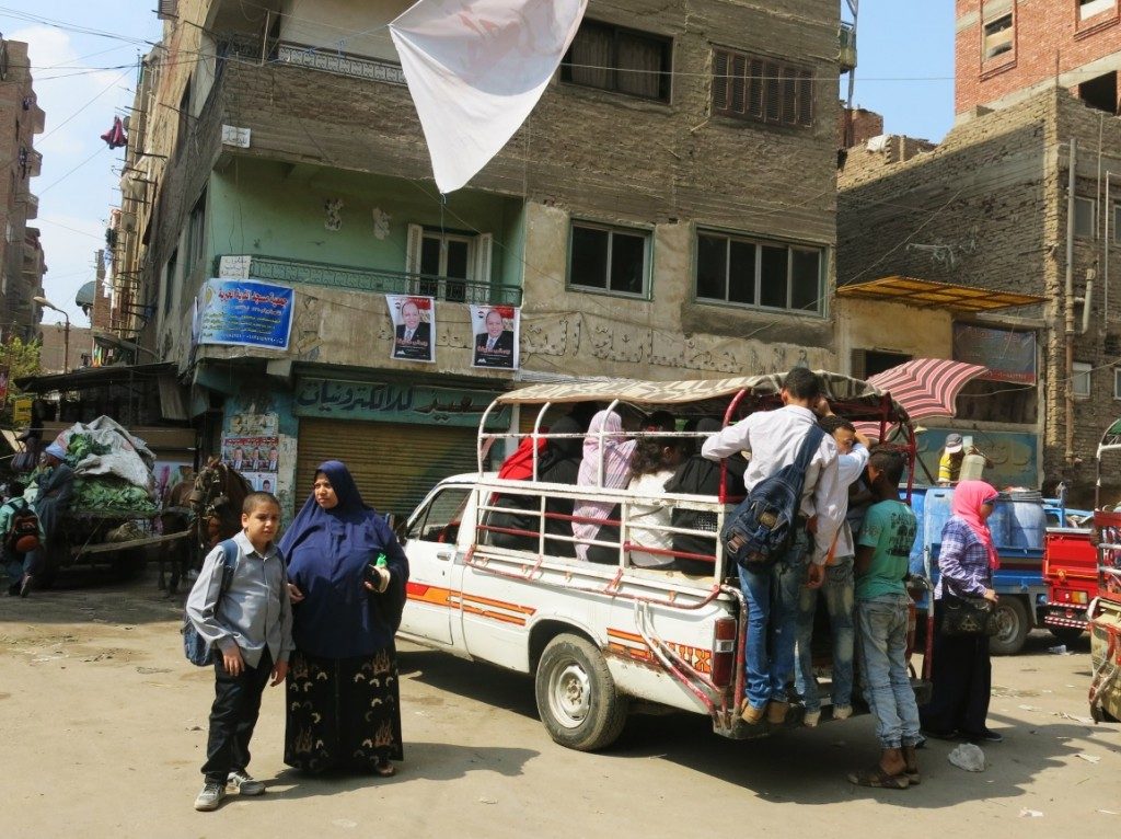 In addition to the tuk tuks and microbuses, pickup trucks modified to transport people are one of the forms of transportation used in some parts of Imbāba. The photograph is of Baṣrāwī Street in al-Munīra al-Gharbiyya. (Tadamun, 2015)